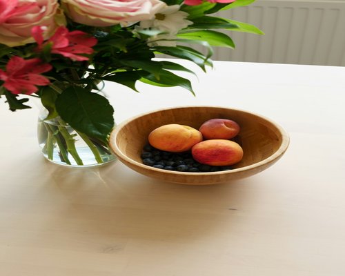 Healthy breakfast bowl with fruits and nuts on table